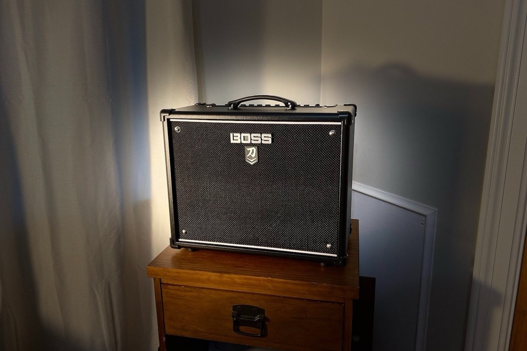A row of guitar combo amplifiers stacked in a music shop, showing the range of sizes and brands a player chooses between