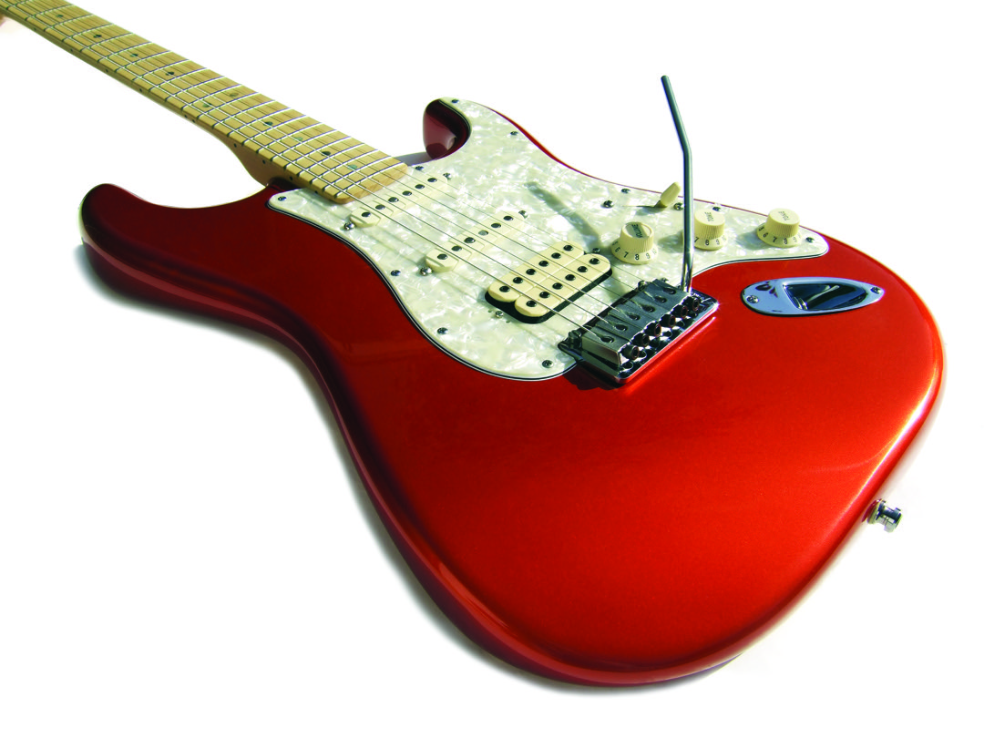 An HSS Stratocaster body showing a bridge humbucker alongside two single coil pickups under a pearl pickguard